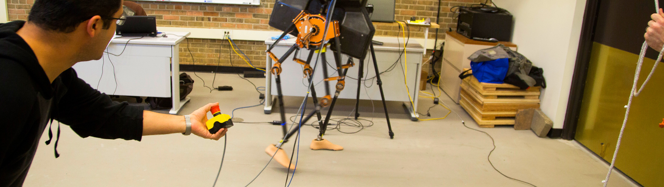 Bipedal robot legs walking in a lab
