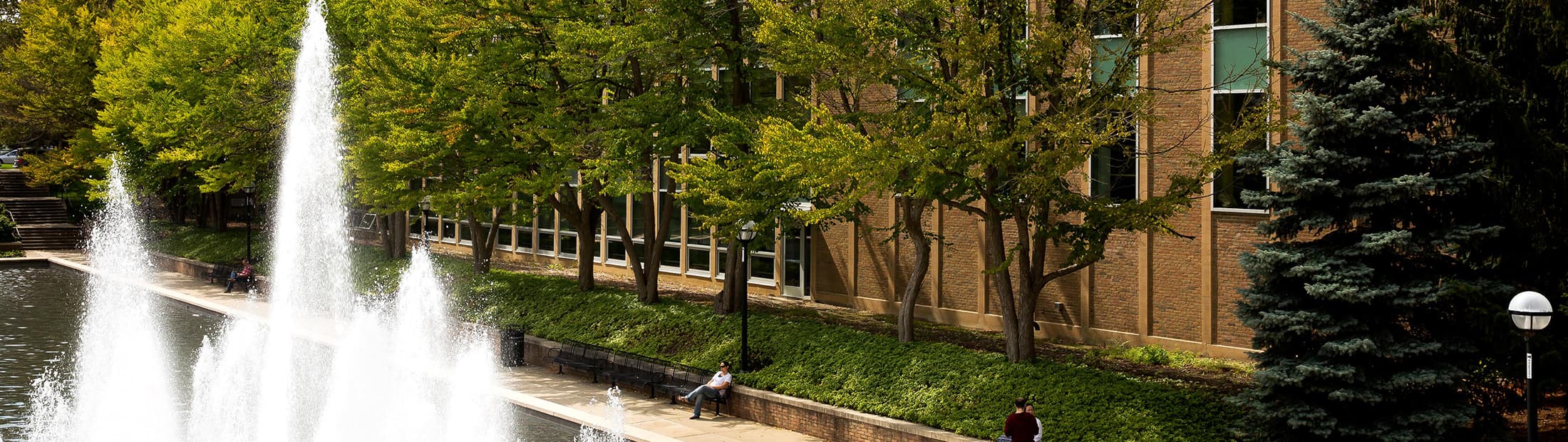 Campus building and fountain on a sunny day