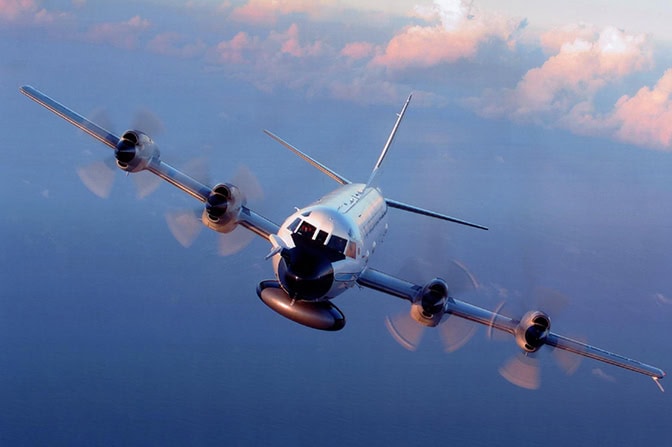 A front view of a plane flying through the sky.