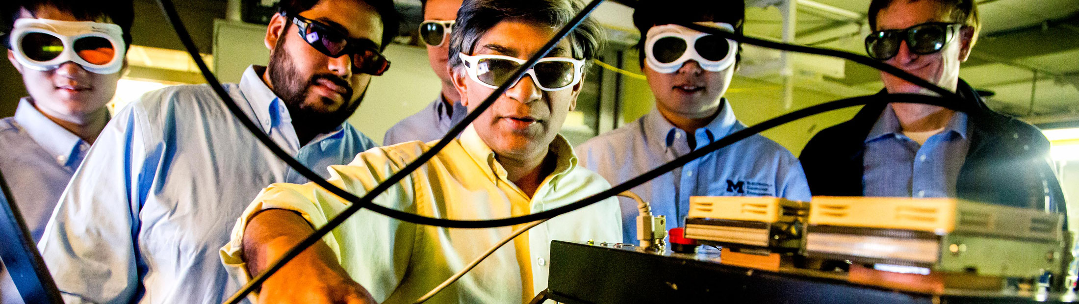 group of researchers wearing eye protection