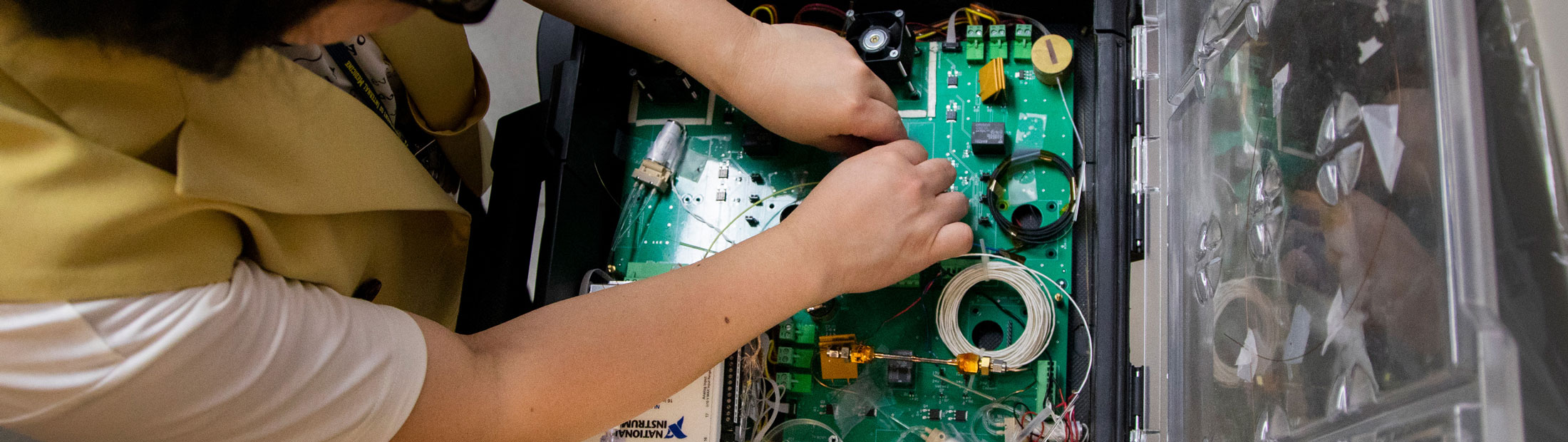 researcher works on the circuit board
