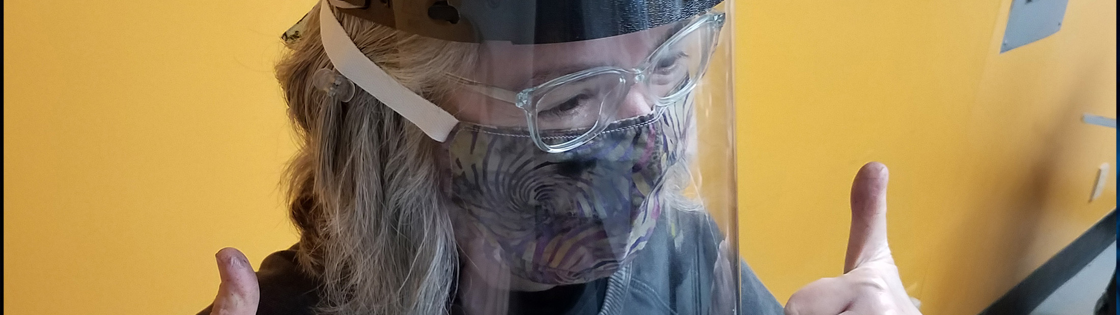 Volunteer trying on face shield