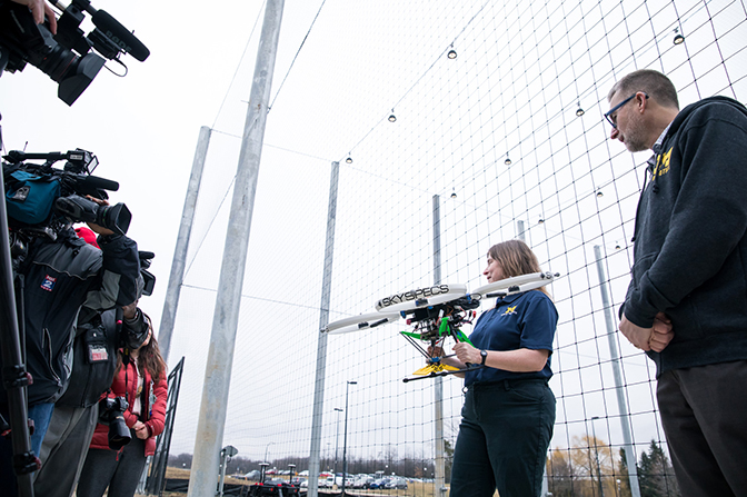 image of professor ella atkins and jessy grizzle of m-air advanced robotics facility talking to media about their new autonomous aerial vehicle