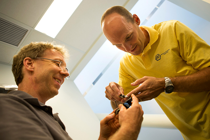 image of two researchers in the michigan integrated circuits lab working on chip installation