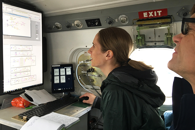 image of two researchers reviewing measurements of methane on screen