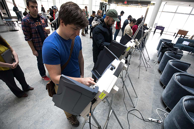 image of students, staff and faculty members casting votes in the mock election