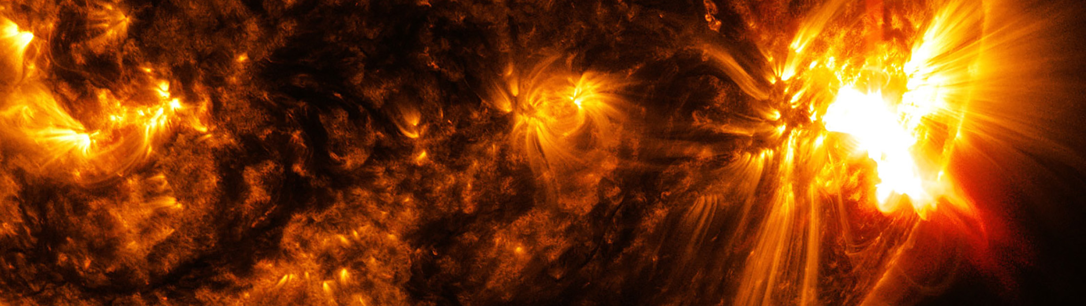 an image of an x2.0-class solar flare bursting off the lower right side of the sun captured by the nasa's solar dynamics observatory