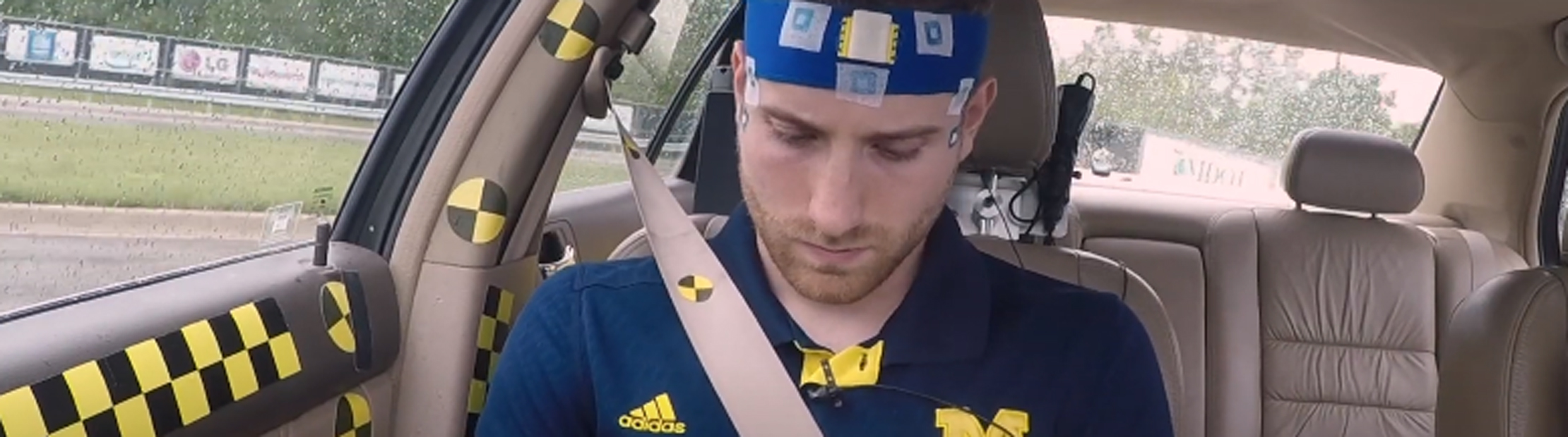 A person in a car wearing health monitoring sensors