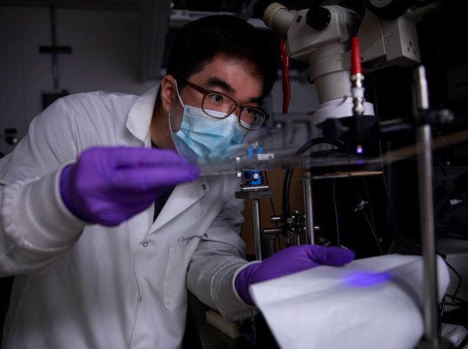 researcher wearing a gloves and mask