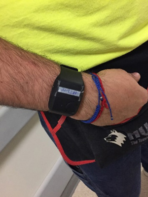 Wristband vitals monitor on wrist of construction worker