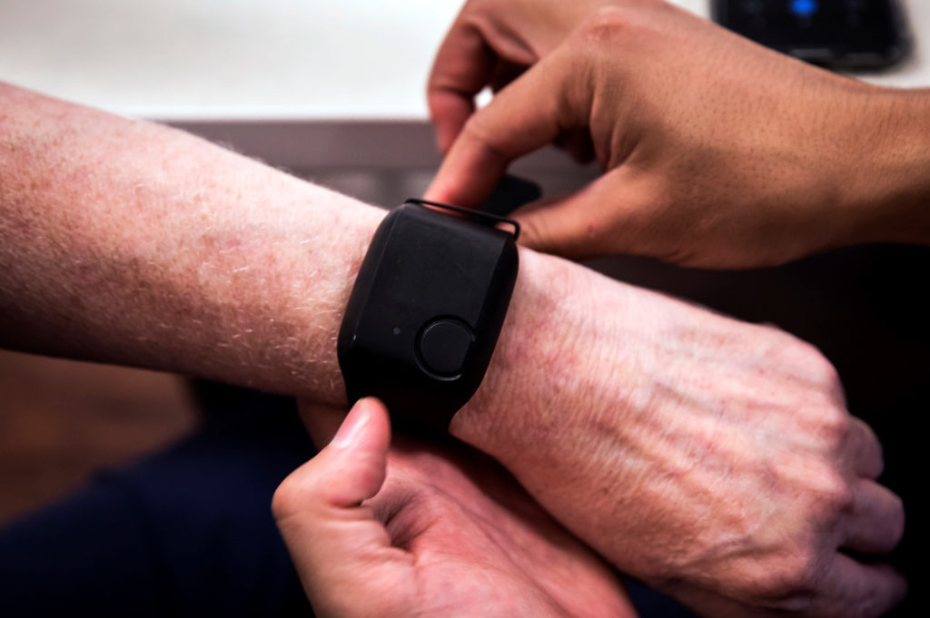 Close up of wearable sensor watch on senior citizen's wrist