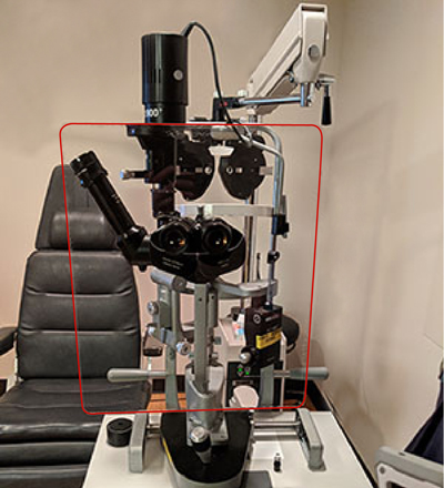 Protective glass shield in front of eye examination device