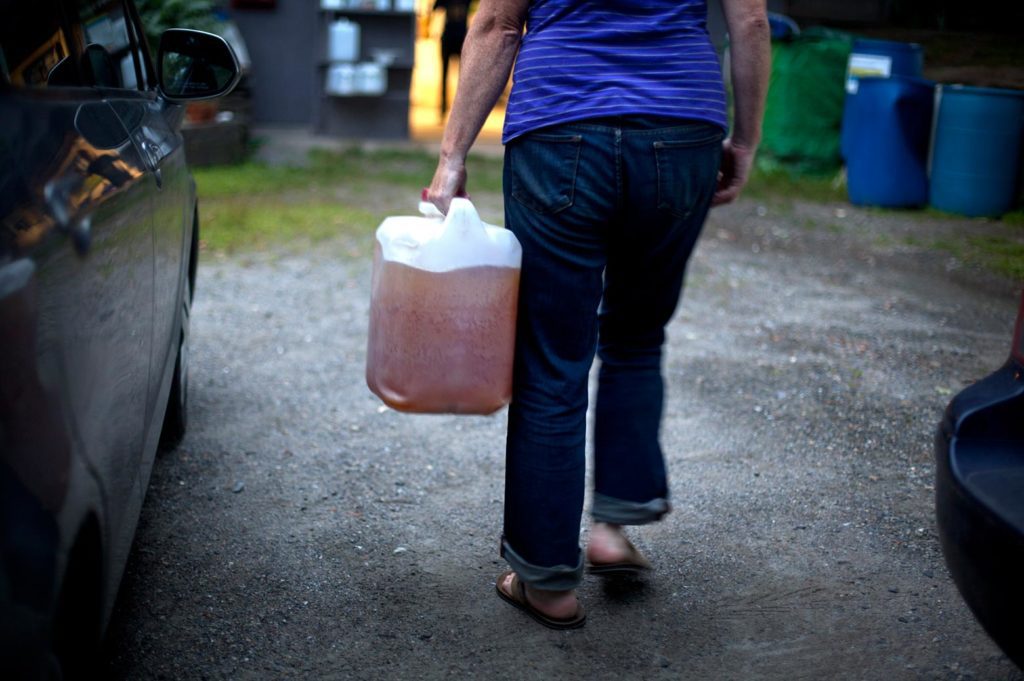 person holding a jug of urine