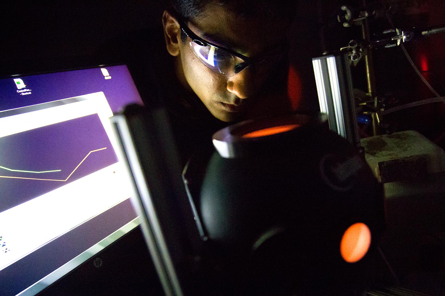 a close up image of umar aslam looking into the light source during the experiment