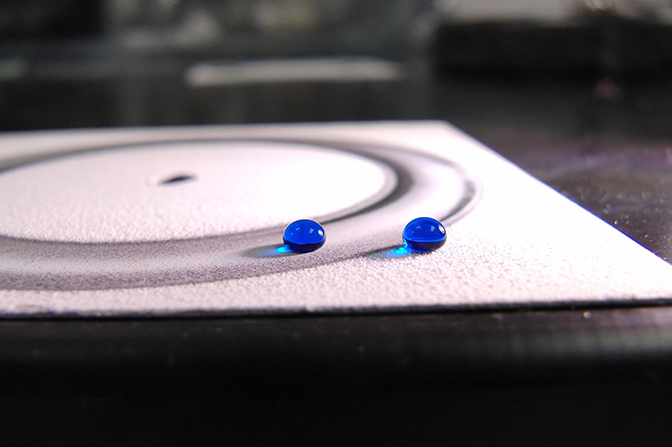 Two blue beads on a flat surface.