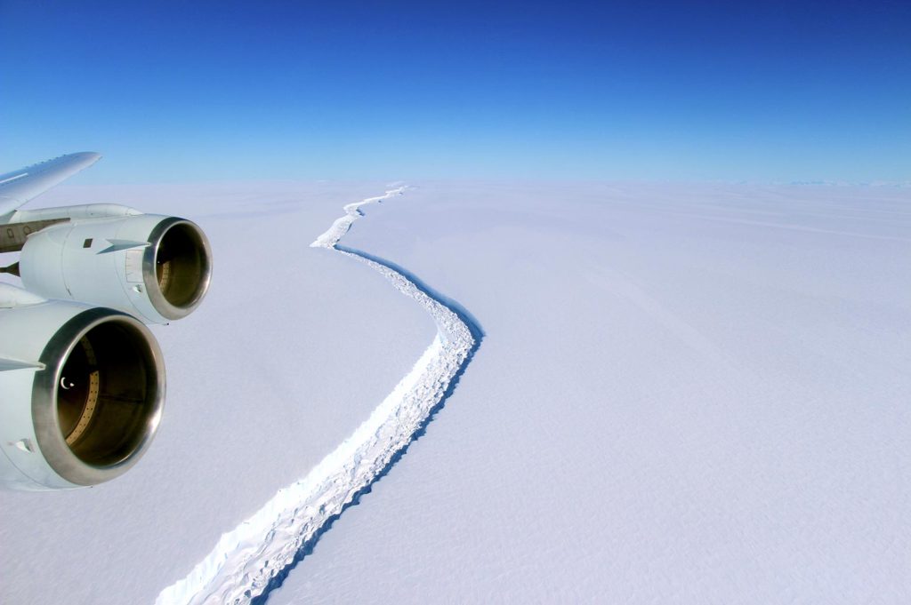 Aerial view of a large crack along the surface of an iceberg