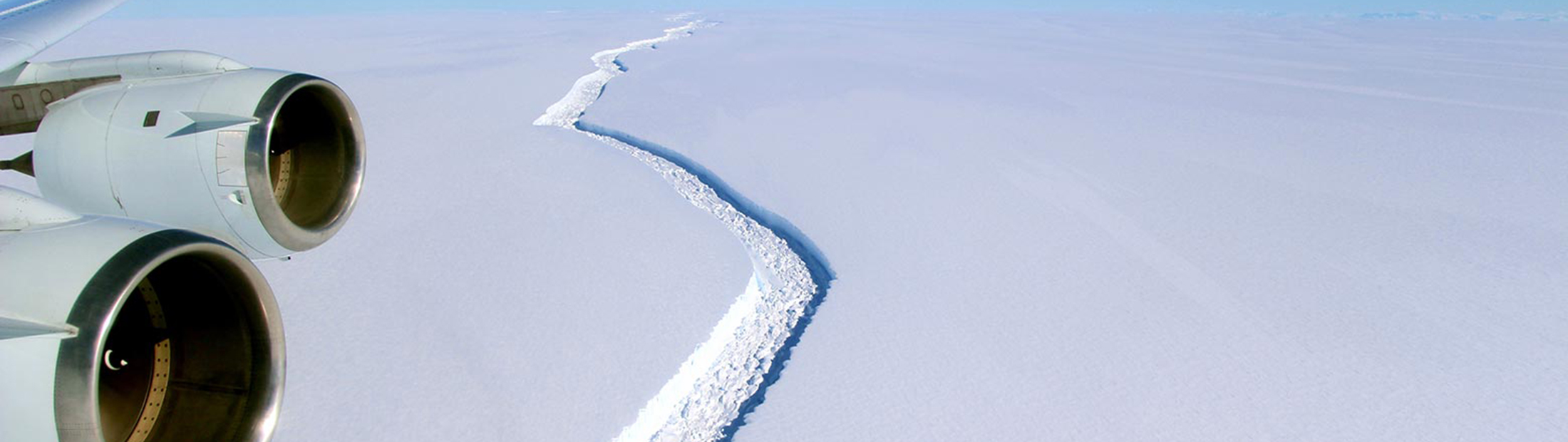 Aerial view of a large crack along the surface of an iceberg
