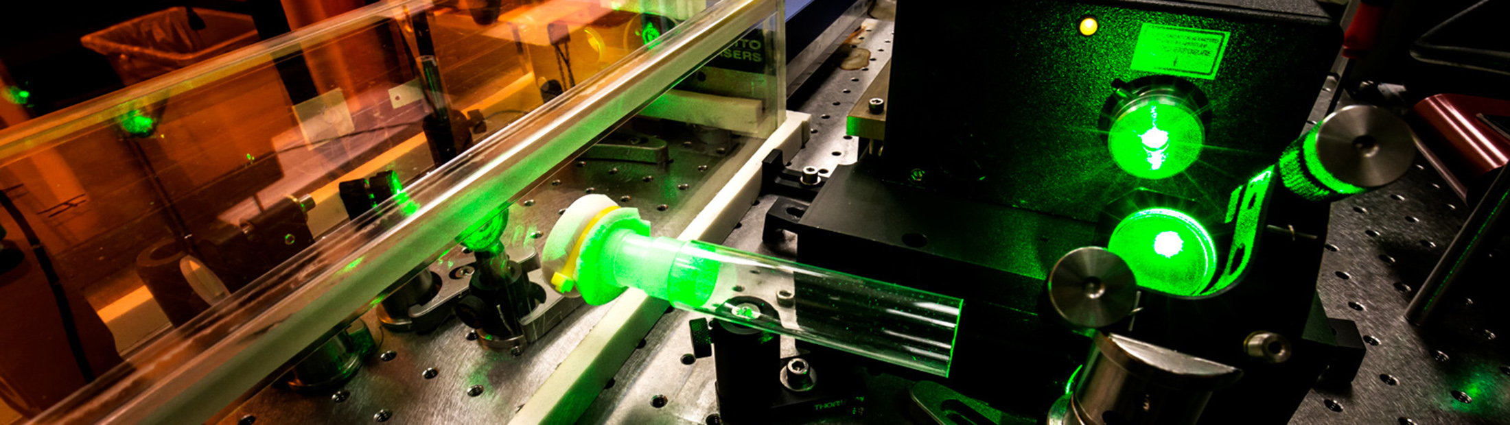 A large machine emitting a green laser.