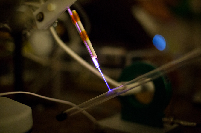 A bright purple beam hitting a clear tube.