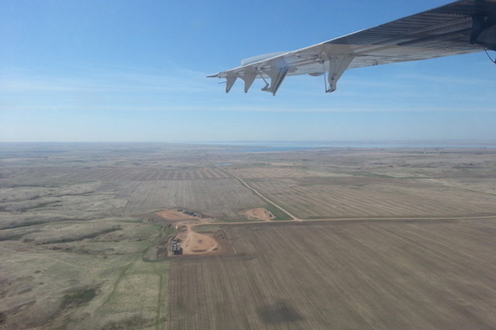 Plane flying over a field