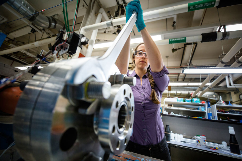 Person demonstrating operation of mechanical engineering equipment