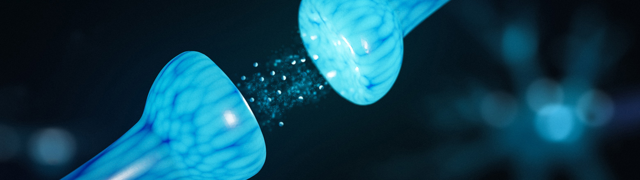 Two blue bulbs facing each other with small particles floating in between.