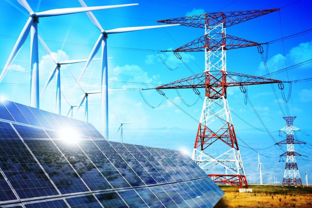 An open field with solar panels, power lines, and wind turbines.