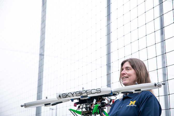 Image of Atkins holding one of her quadcopters outdoors on the M-Air media day