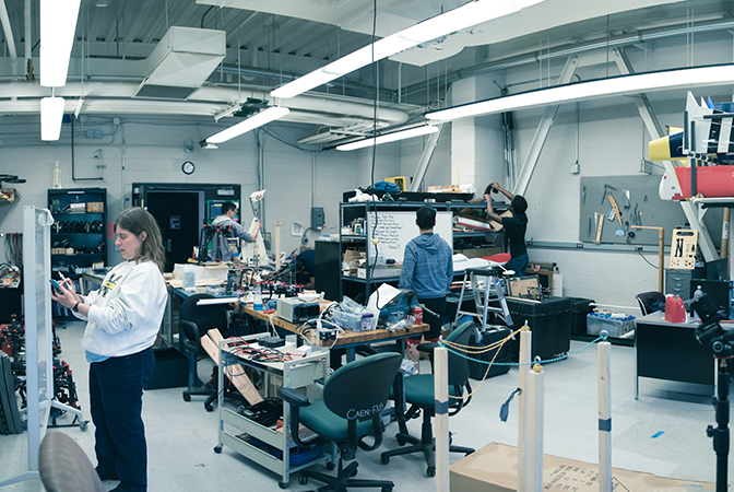 Image of Autonomous Aerospace Systems Laboratory with Atkins and her students working.