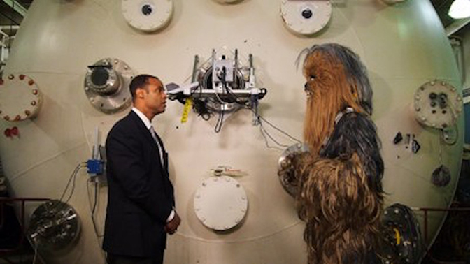 Professor Alec Gallimore and Chewbacca talking to each other in front of a large device.