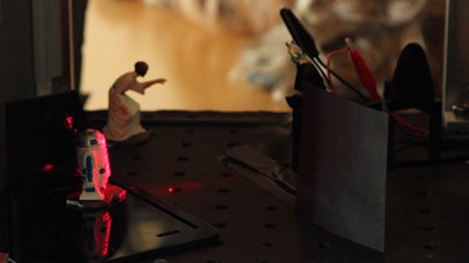 A closeup of a desk with Star Wars figures.