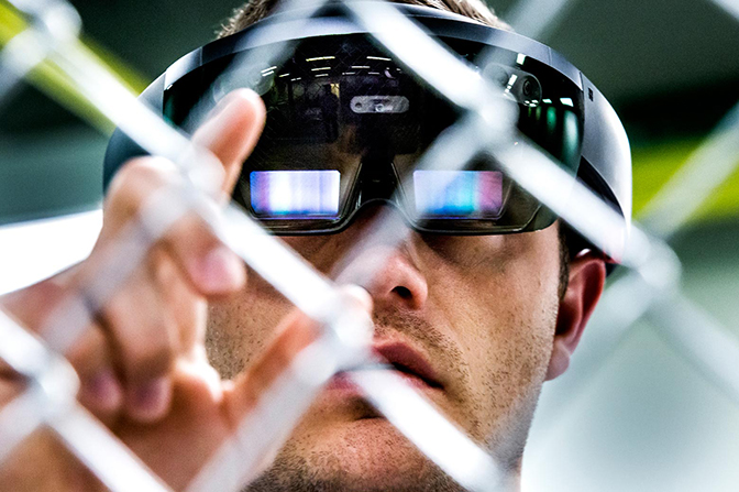 A close up image of Michael Hamel testing a Microsoft HoloLens headset.