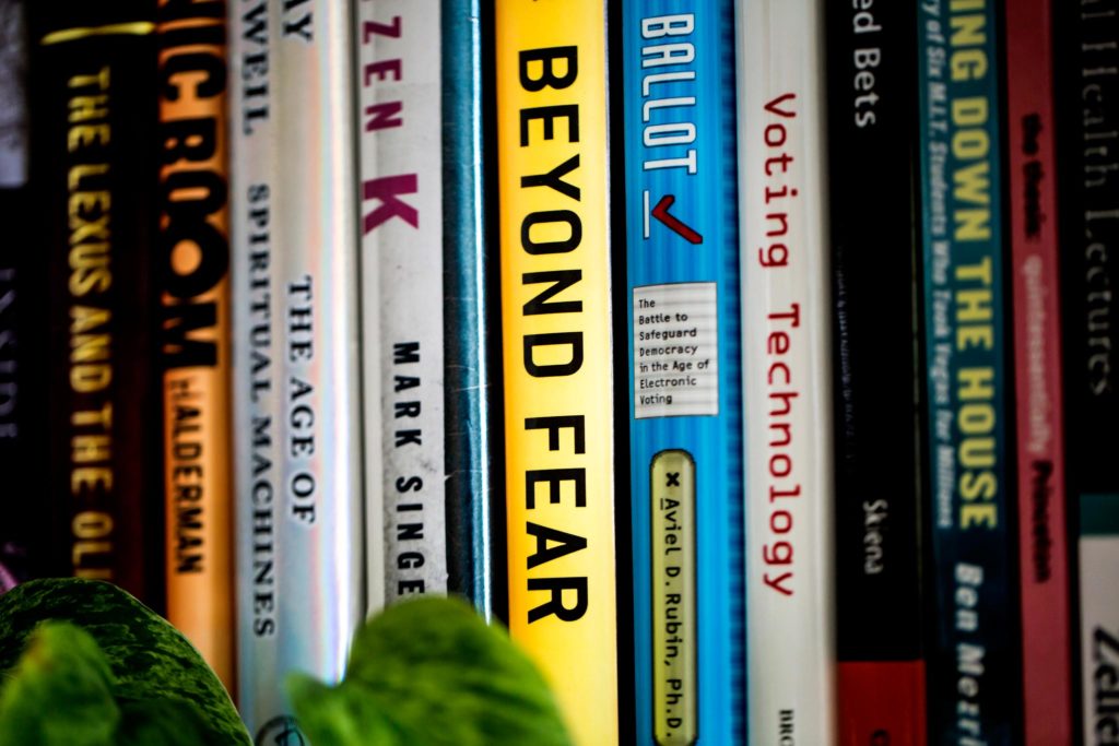 A closeup of the spines of books.