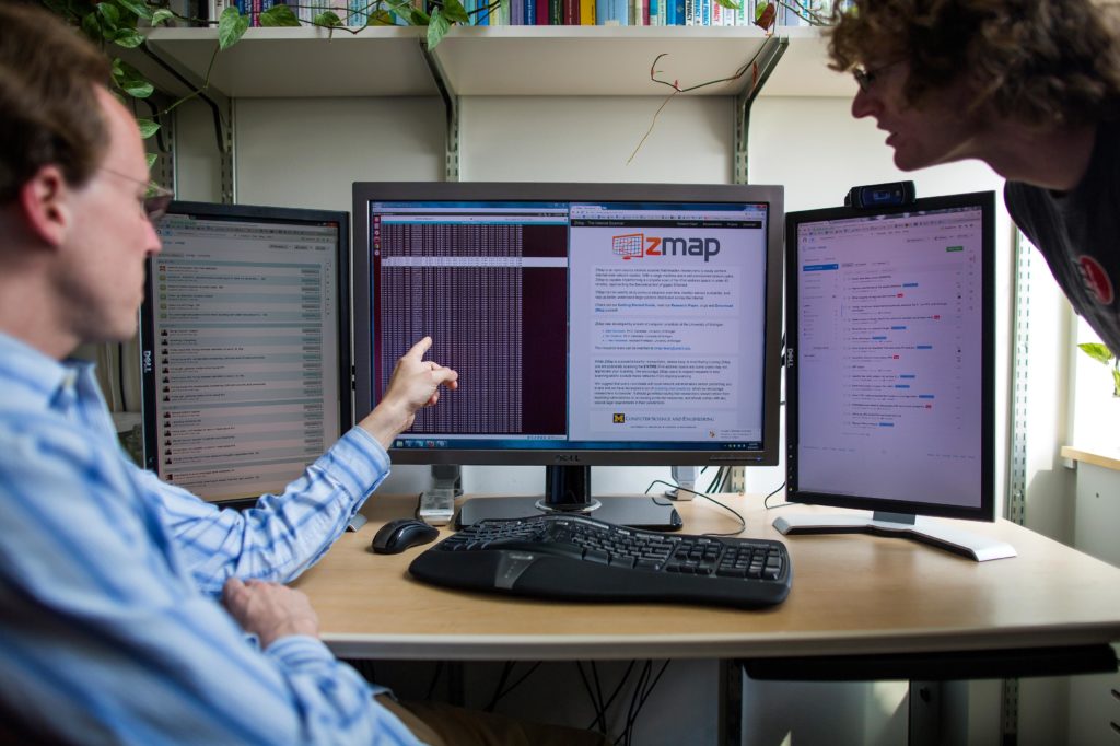 A man pointing at a computer screen.