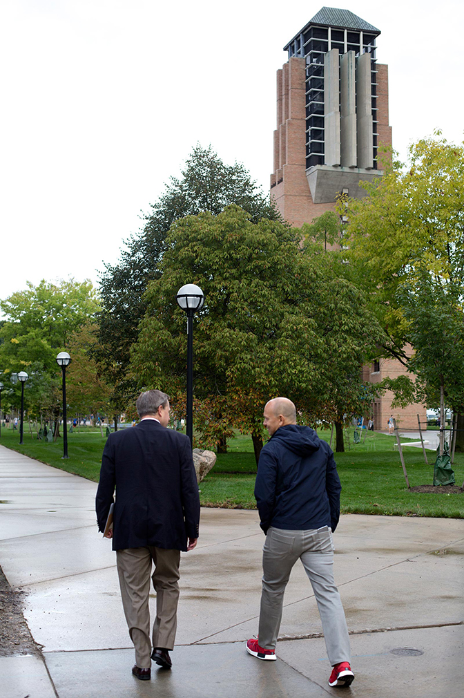 Rear image of Fadell walking on College of Engineering campus.