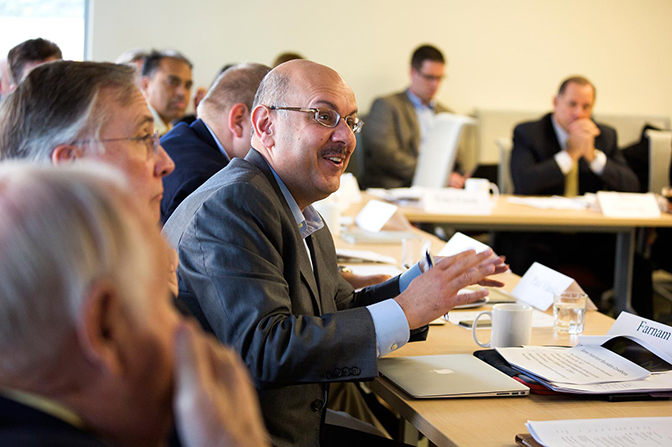 Several people speaking at a meeting.