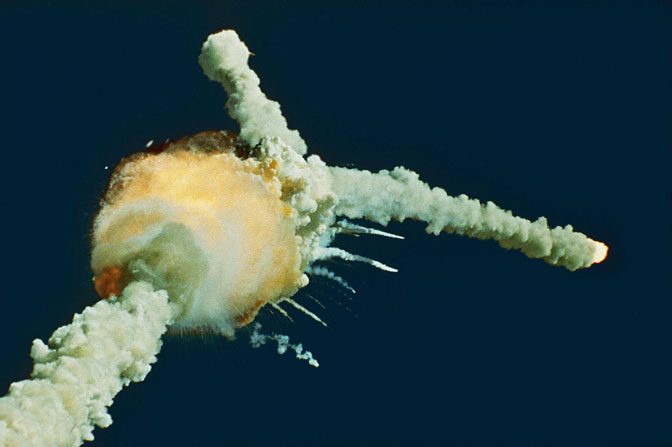 The space shuttle Challenger explodes