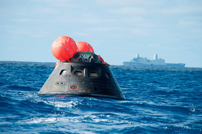 The Orion crew module floating on the ocean