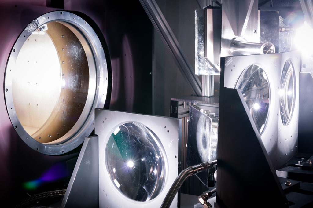 Light comes through the complex metal interior of an IMAX movie projector 