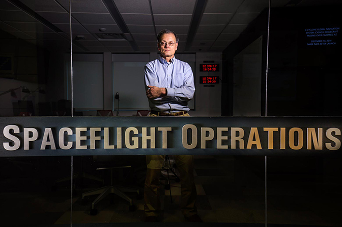 A man standing behind a sign that reads "Spaceflight Operations".