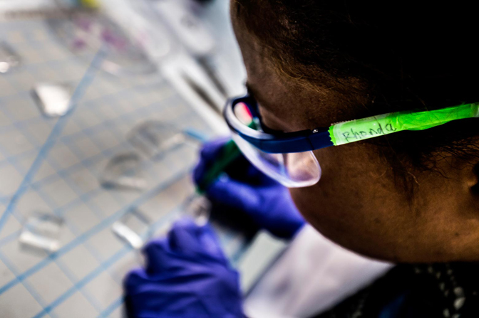 Rhonda Jack cuts a plastic chip into smaller pieces to build a device. Photo: Joseph Xu