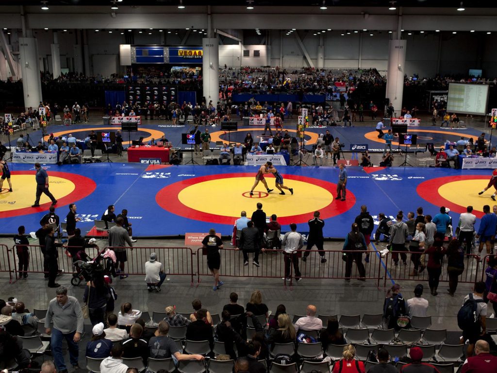 A gym full of wrestling rings.