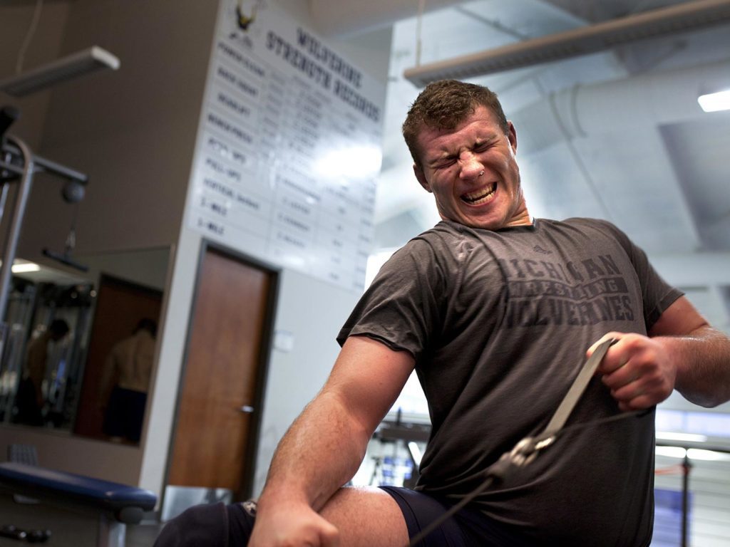 A person lifting weights in a gym.