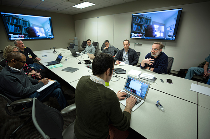 Images of researchers from the College of Engineering and Michigan Medicine in a conference room during national emergency due to COVID-19