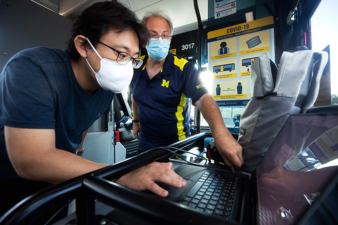 Image of Taehoon Han and Andre Boehman reviewing preliminary aerosolization data