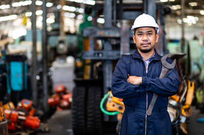 A worker standing with a wrench