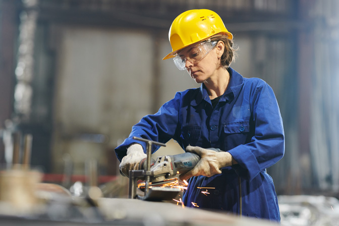 A worker using a tool in a garage