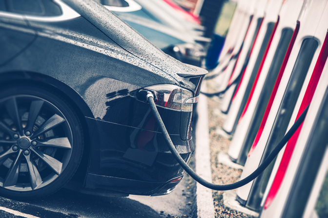 An electric car plugged into a charging station