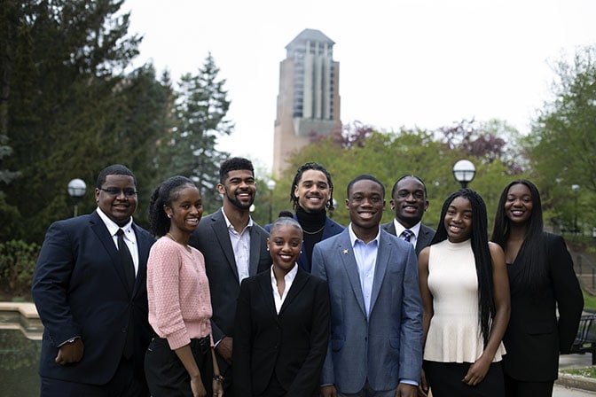 Members of the NSBE Chapter Executive Board pose for photos in front of the reflection pool on North Campus.
