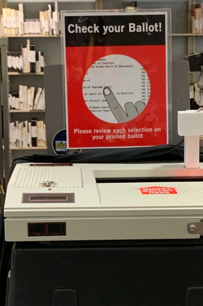 The electronic ballot box with instructions above it.